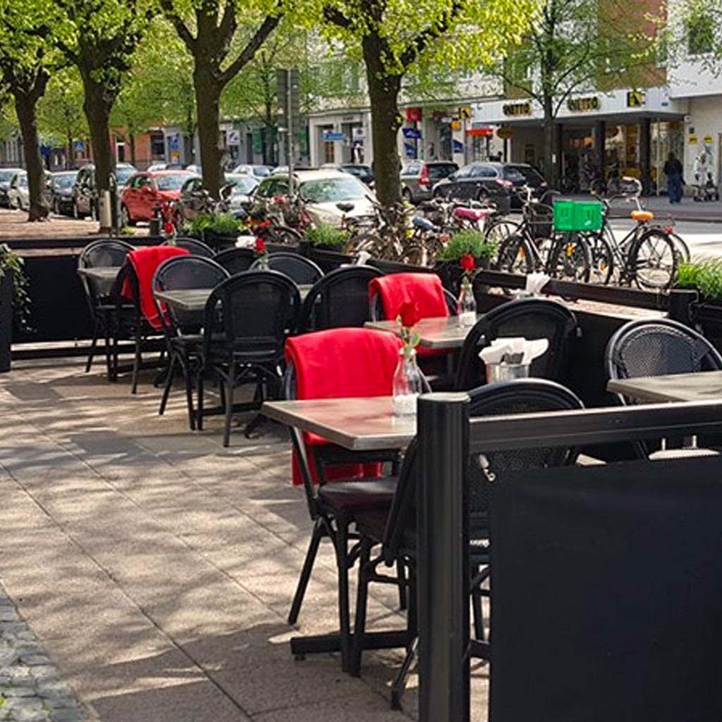 An outdoor dining area with tables and chairs.