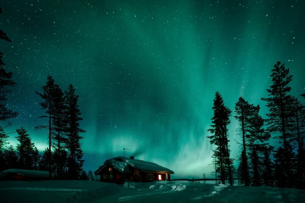 northern lights aurora borealis activity over forest norrland sweden