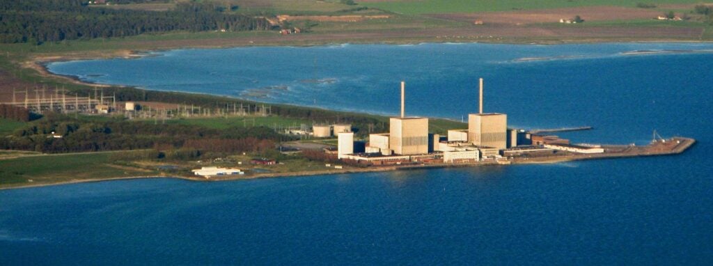 An aerial view of a power plant near a body of water.